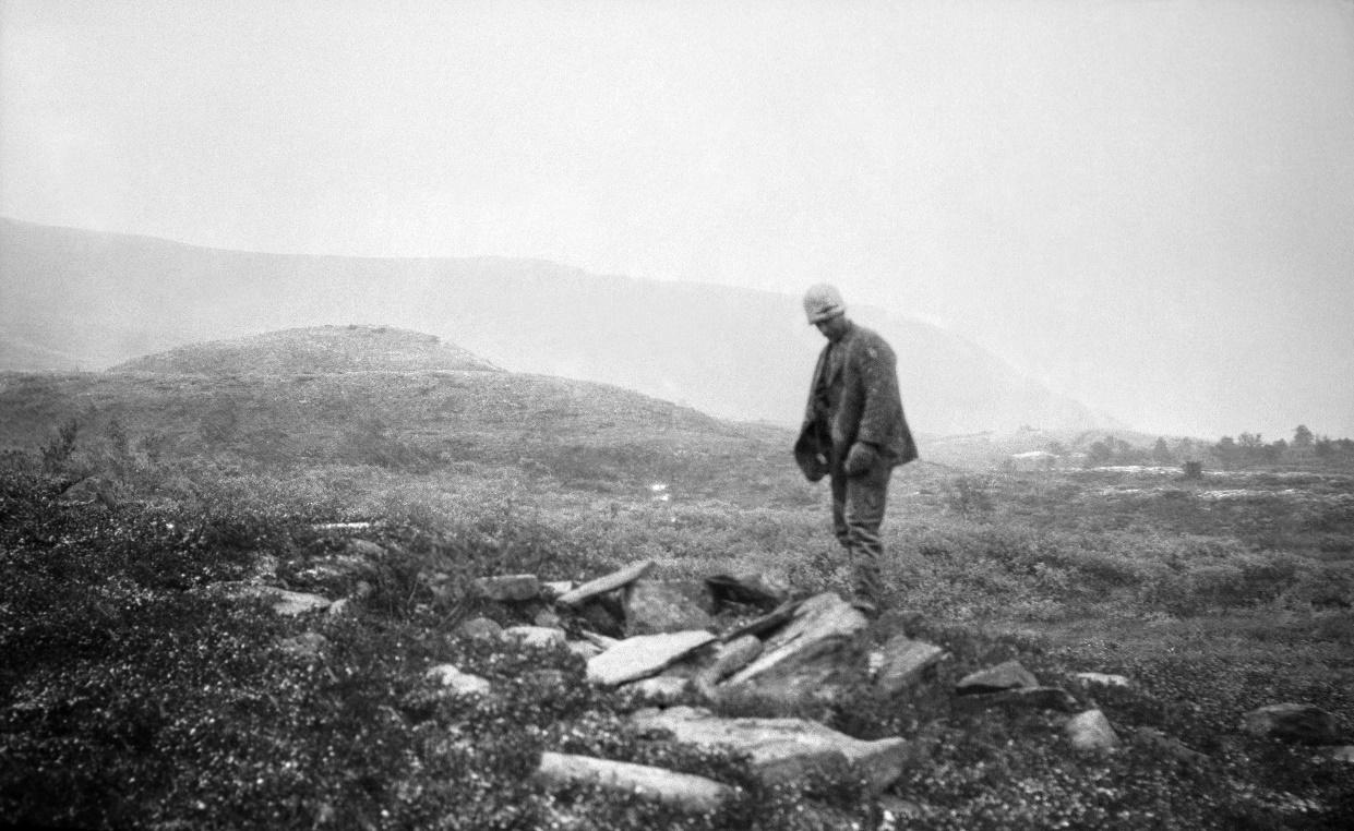 Man at prehistoric Sami grave site.